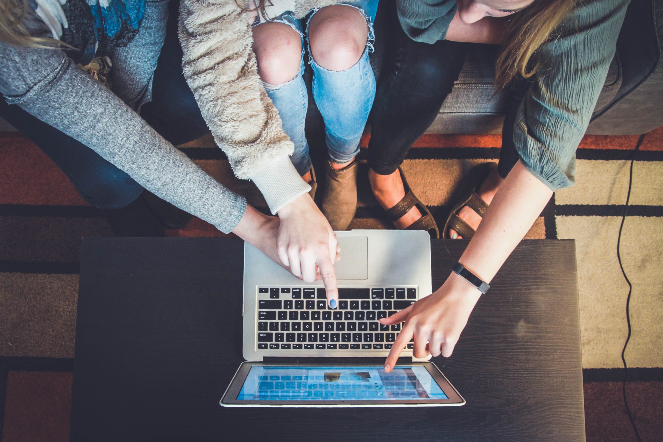 People pointing to a computer